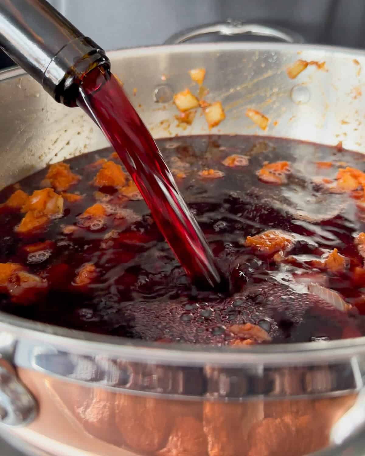 Add the red wine to the pot.