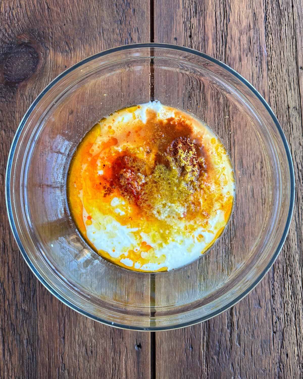 A large bowl with the yogurt marinade ingredients.