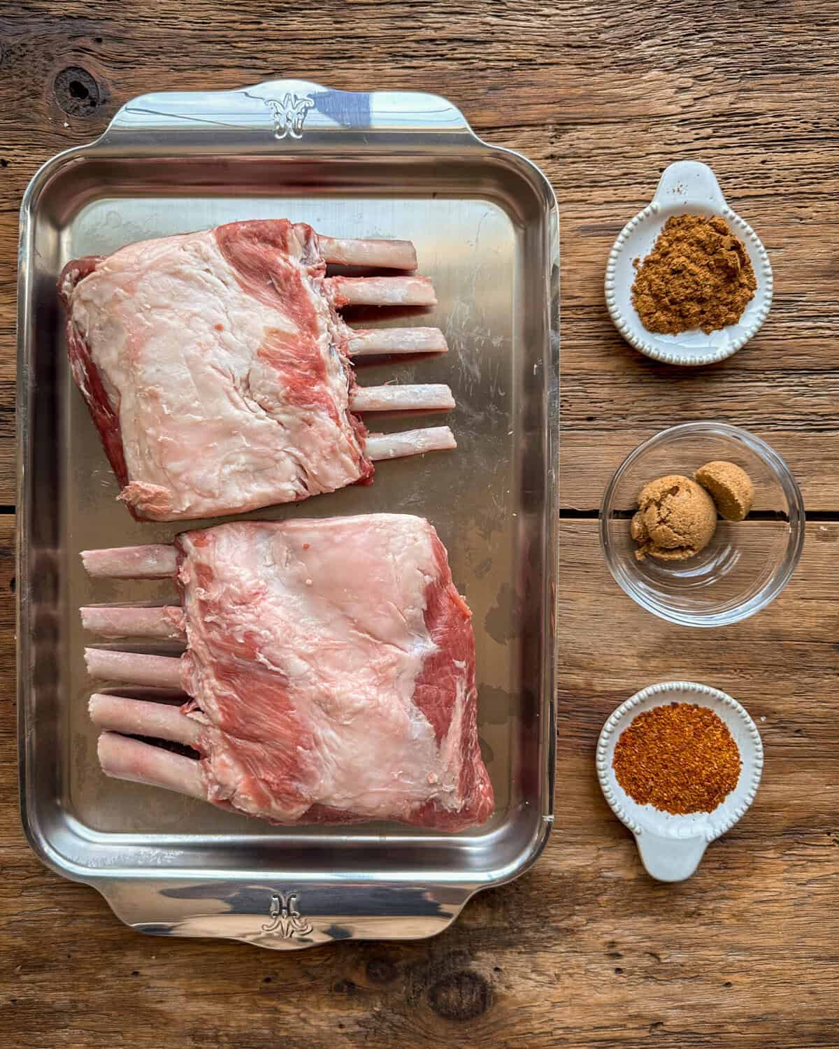 Two wild boar rib racks and spices for a rack of wild boar recipe.