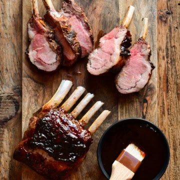 Two wild boar rib racks glazed with a Chinese Five-Spice sticky sauce. One rack is sliced.