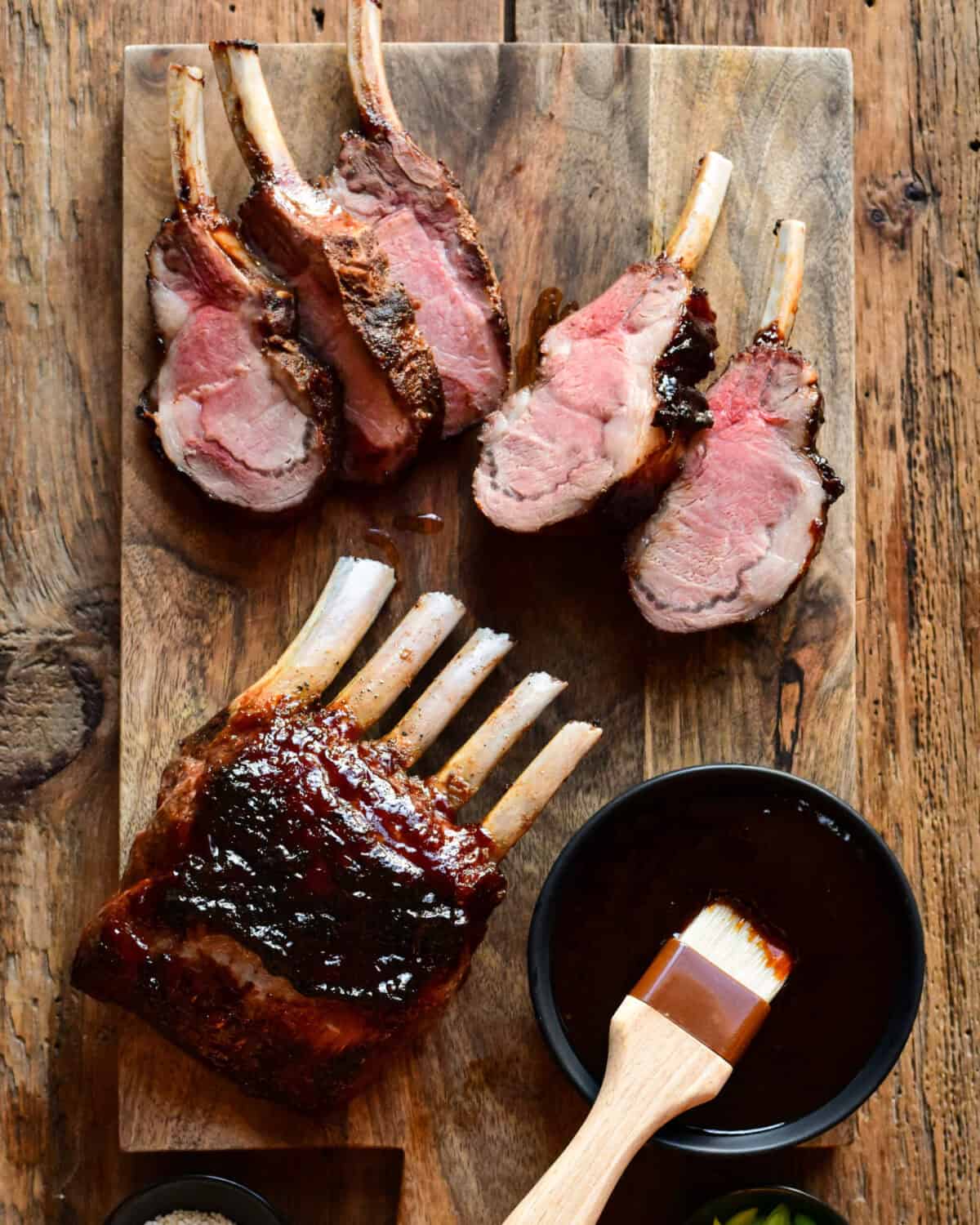 Two wild boar rib racks glazed with a Chinese Five-Spice sticky sauce. One rack is sliced.