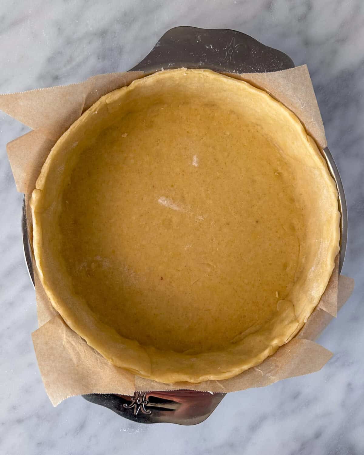 Trim any excess quiche dough extending over the top.