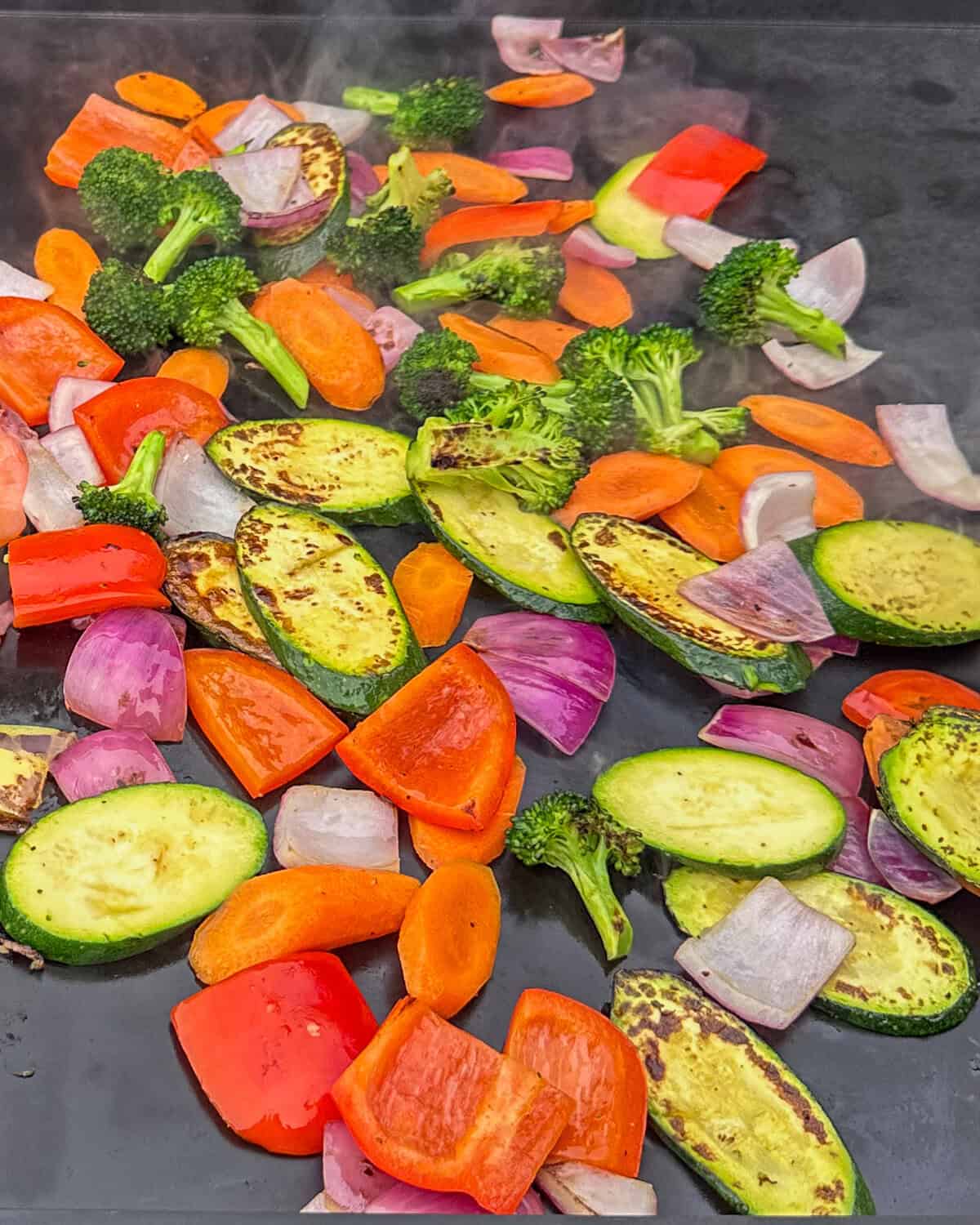 A variety of griddled vegetables on a griddle.