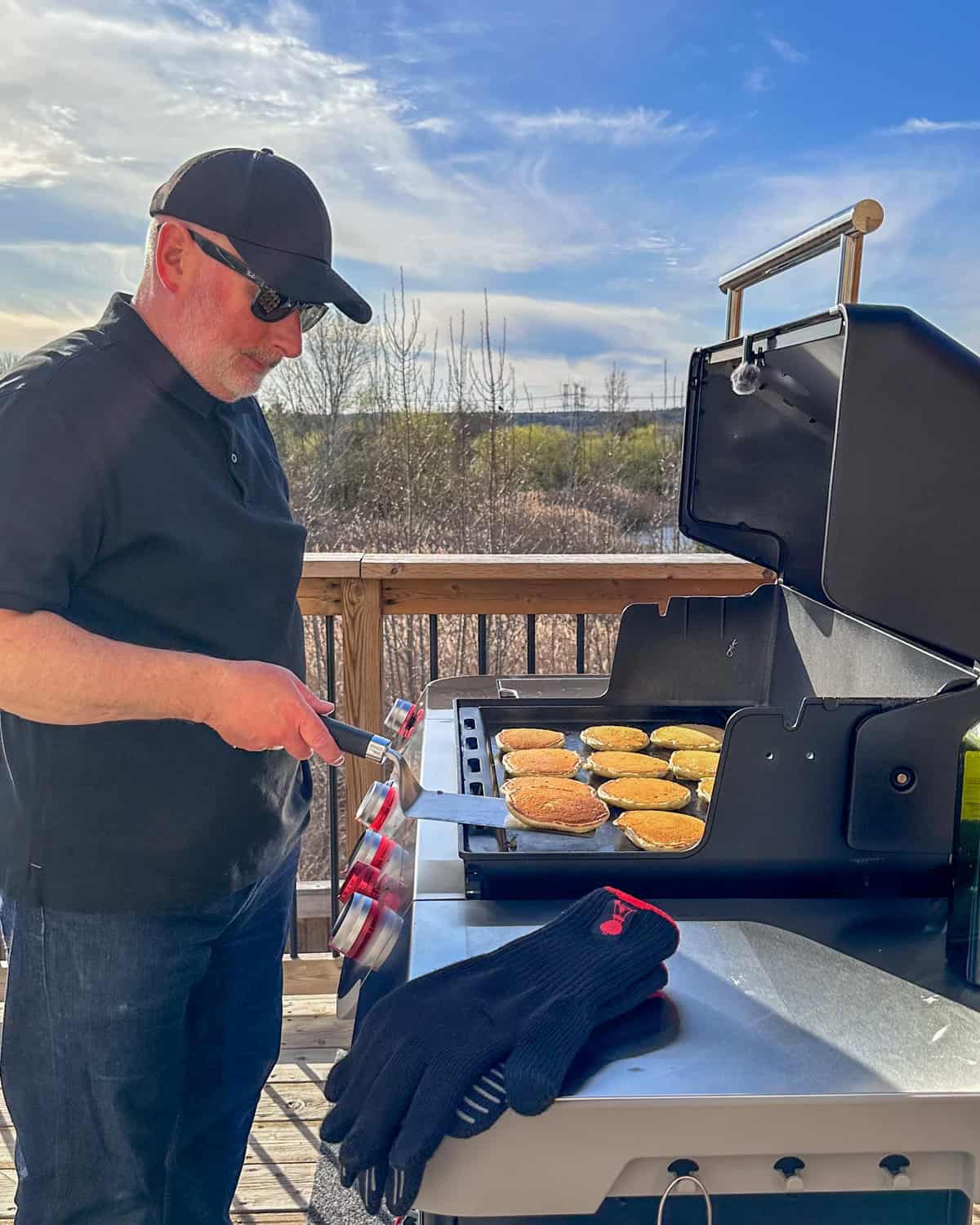 Flipping perfect golden pancakes on griddle whick will be topped with smoked salmon.