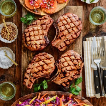 Four reverse seared pork chops served with an orange salsa and a smoky mojo red cabbage slaw.