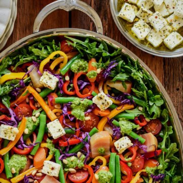 A Warm Rainbow Veggie Salad served with Fresh Summer Pesto and marinated feta cheese.
