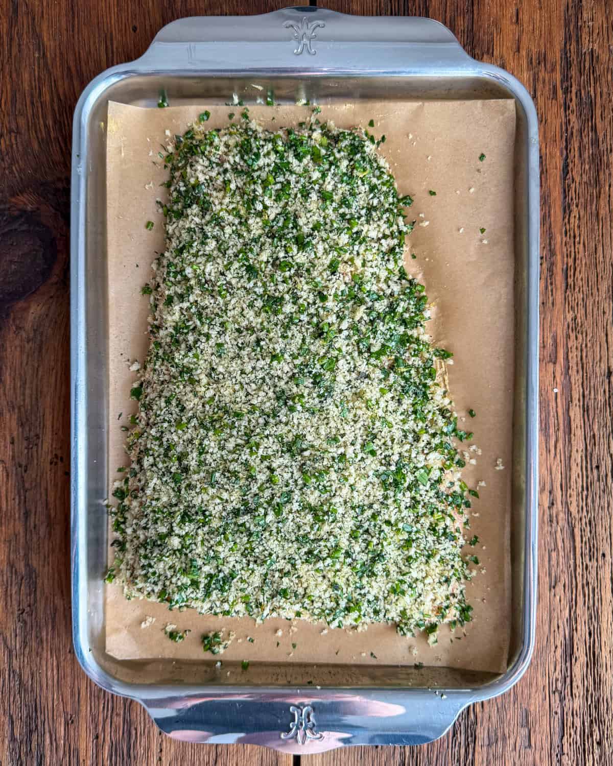 Gently press the herb-panko mixture onto the top to form an even crust on the salmon.