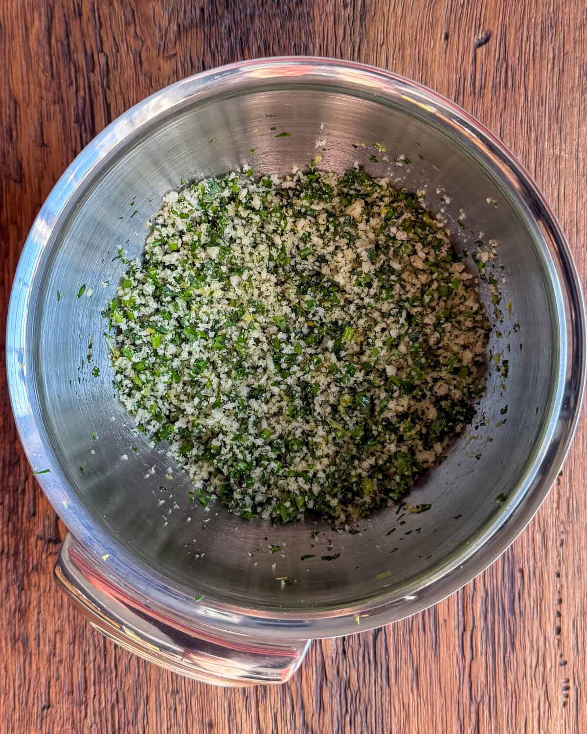 A bowl of herb panko crust mixture for a recipe for herb crusted salmon recipe.