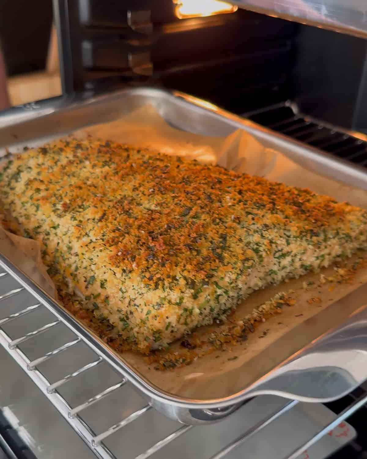 Herb crusted salmon baked in an air fryer.