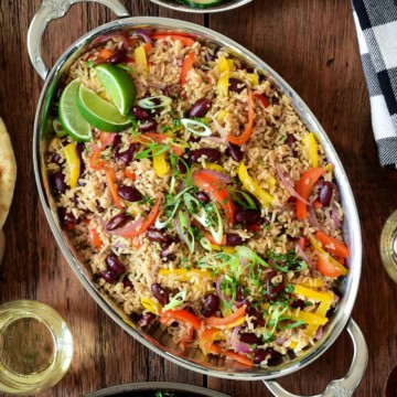 An oval platter of a Caribbean-Style Rice with Red Beans and Peppers.