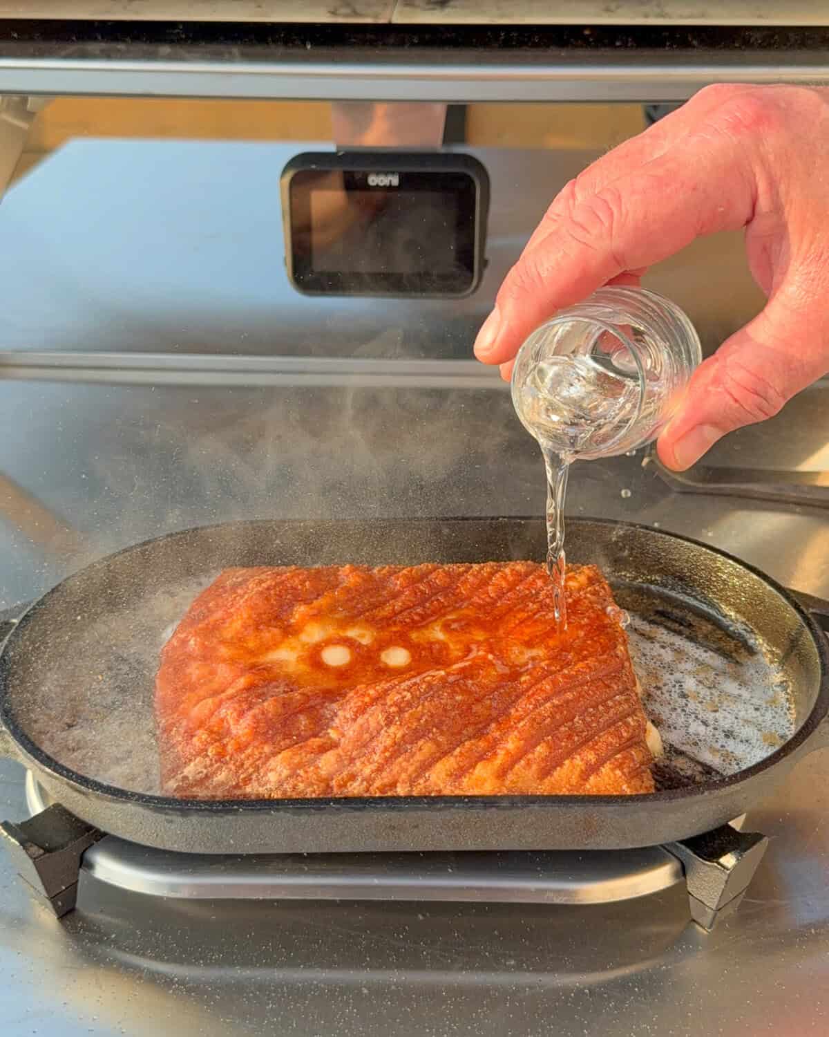 Pour the baked Greek fried cheese with ouzo.