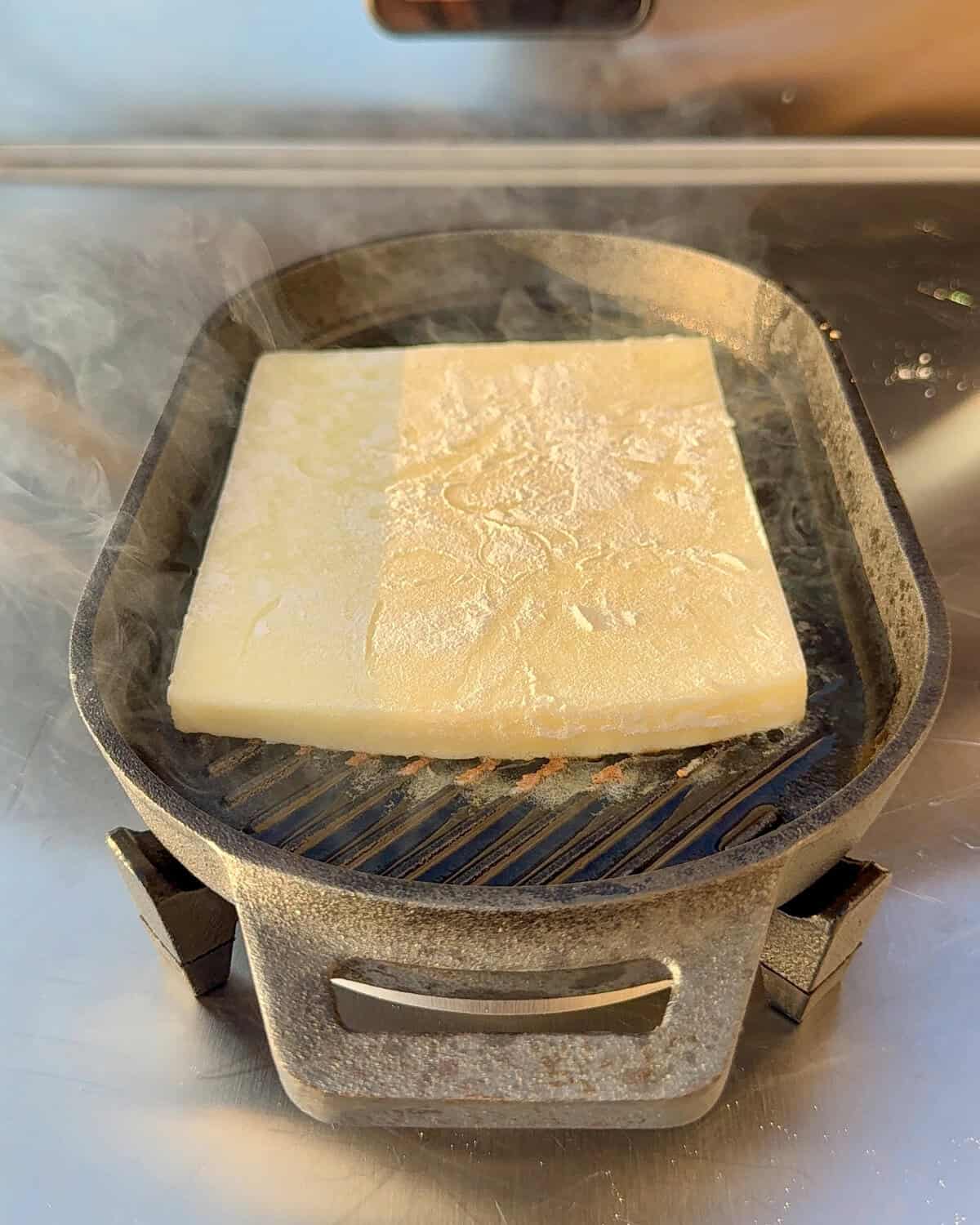 Place the kefalotyri cheese in a preheated skillet.
