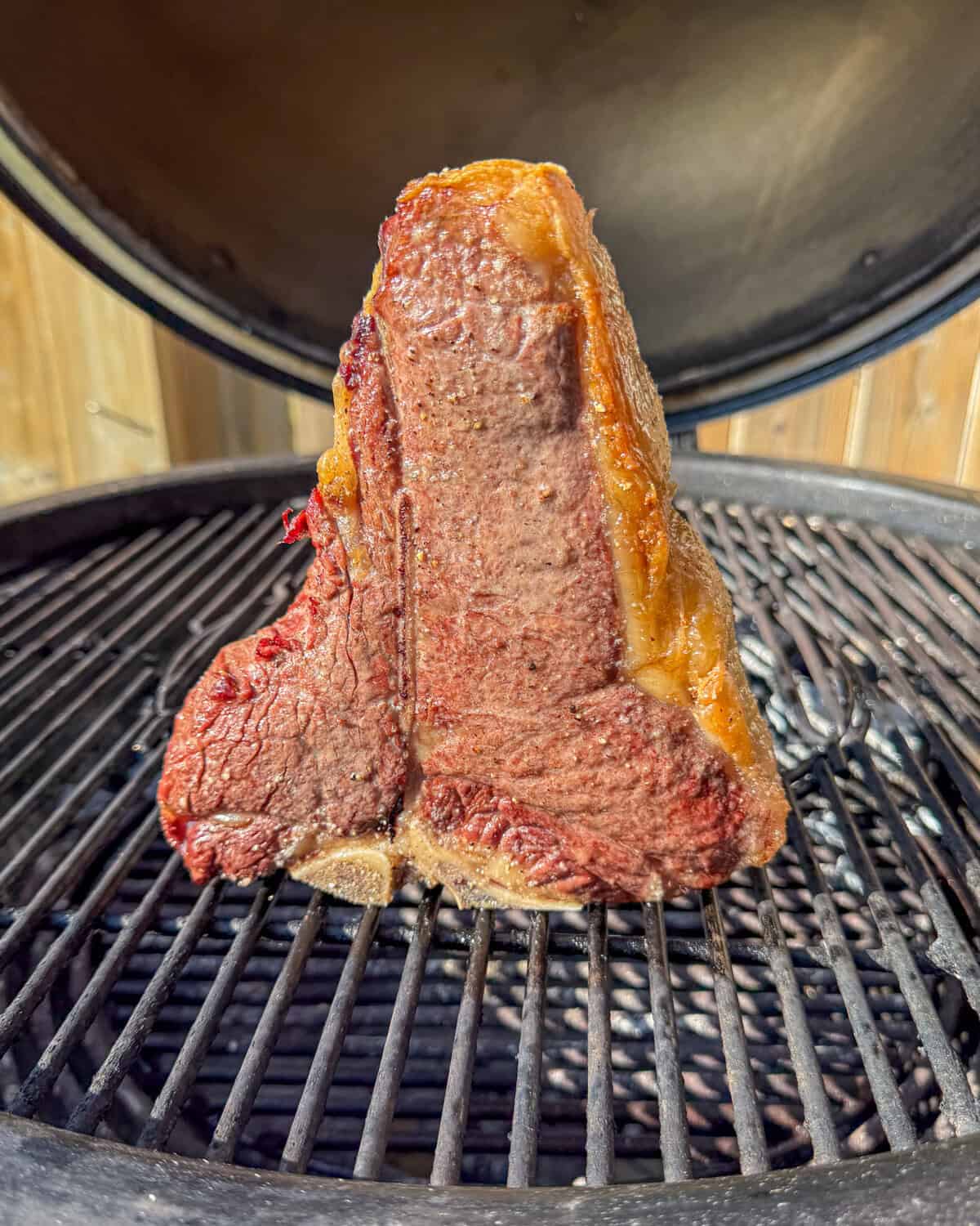 A cooked steak on a grill for a surf & turf recipe.