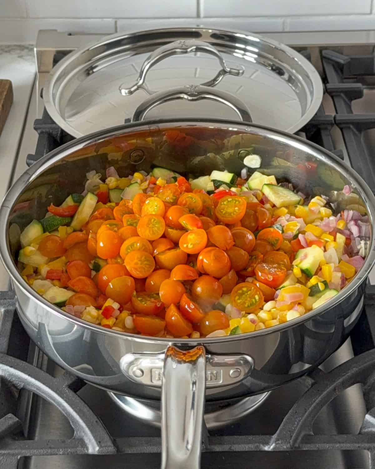 Add the cherry tomatoes to the shakshuka pan.