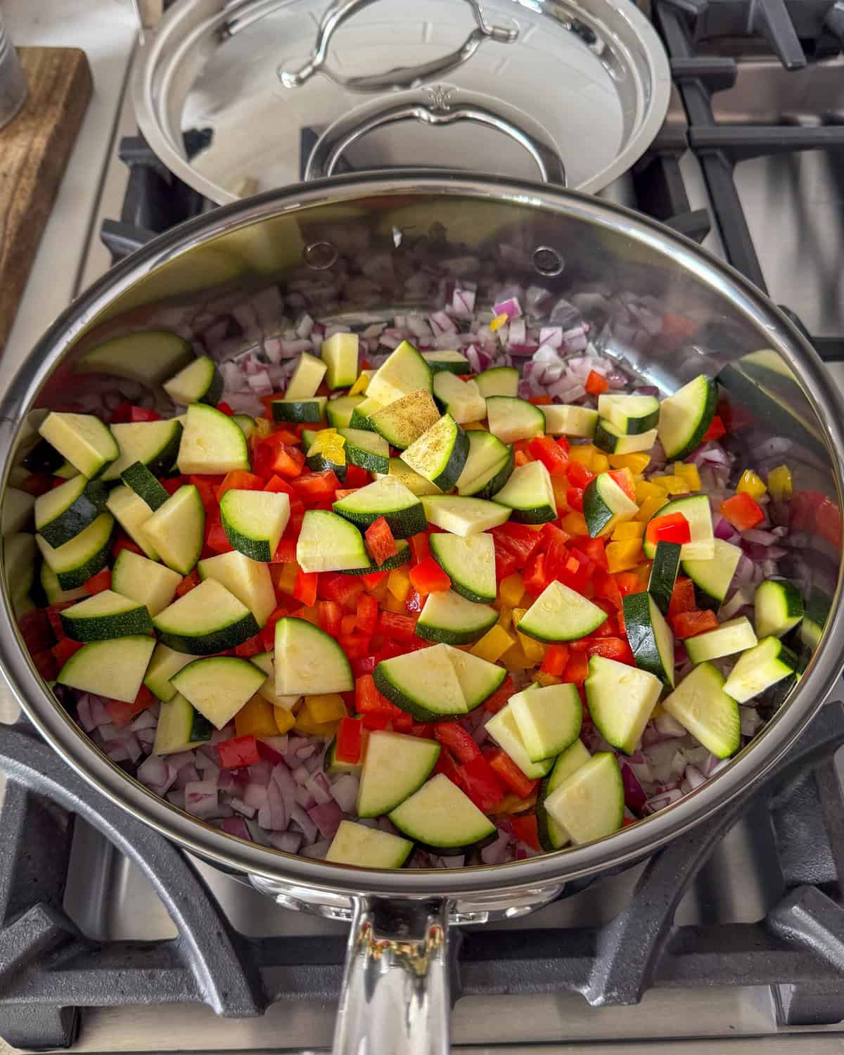 Sautéing a veggie shakshuka in a pan.