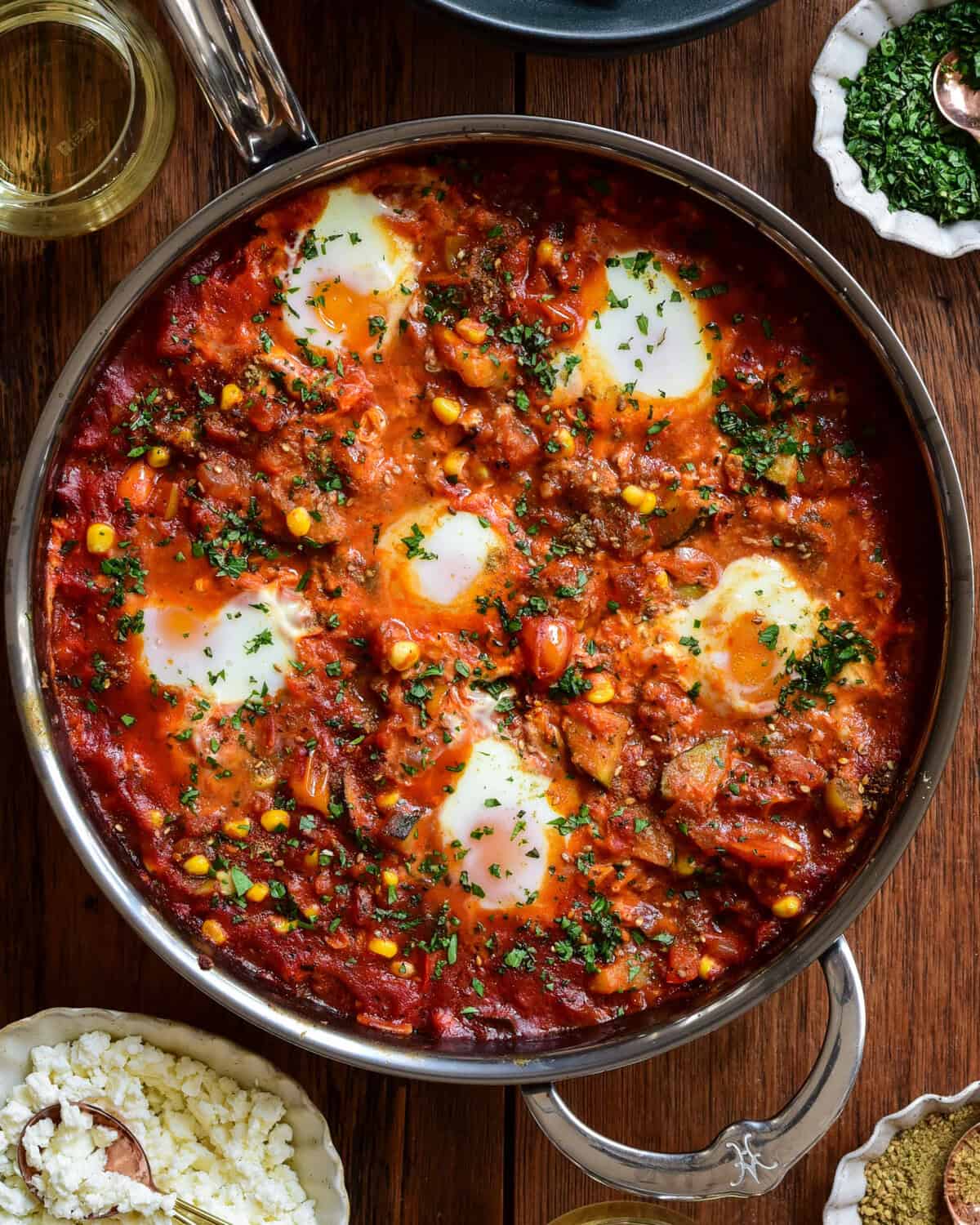 A baked summer vegetable shakshuka with six eggs.