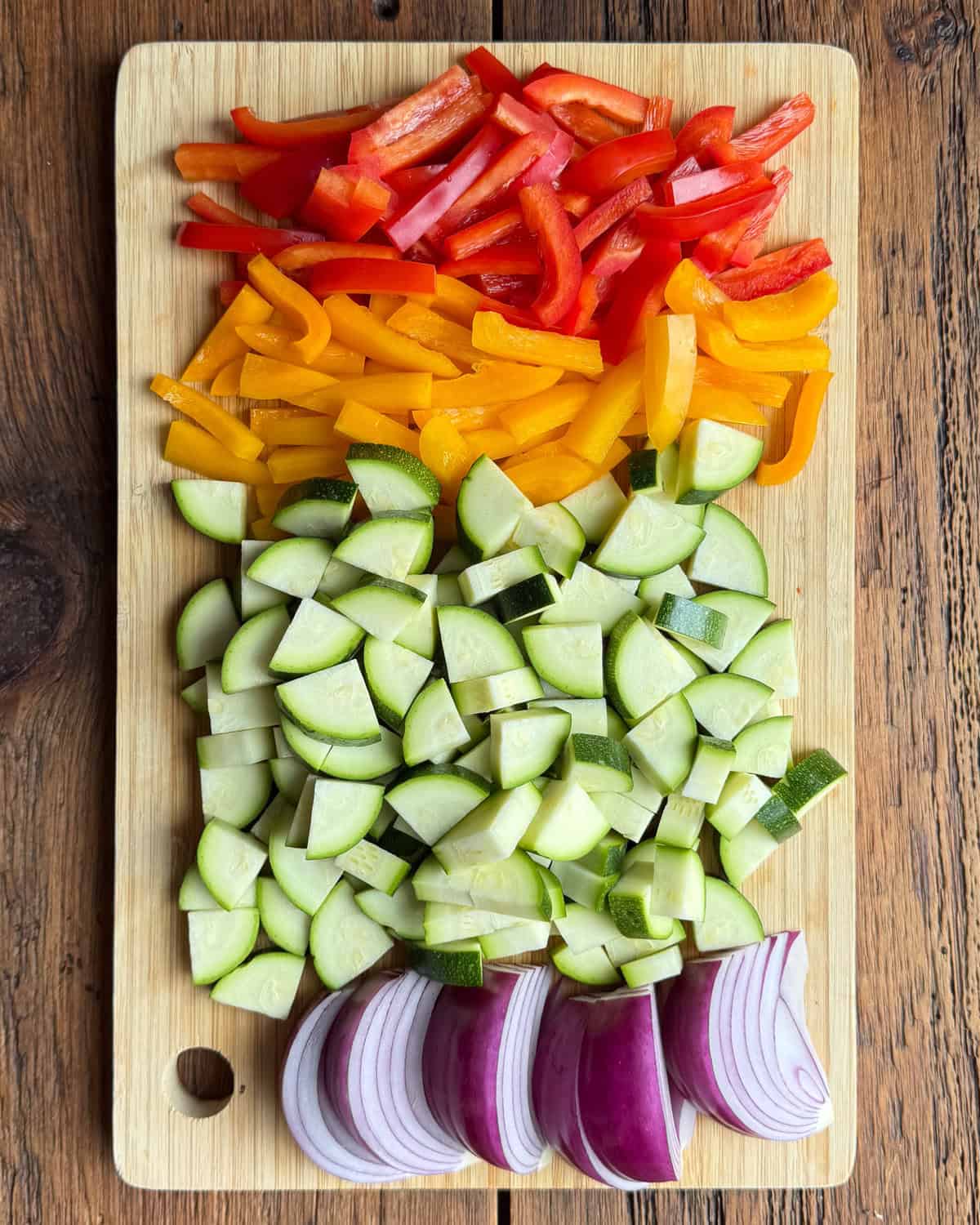 Chopped veggies for a chicken pasta salad with roasted vegetables.