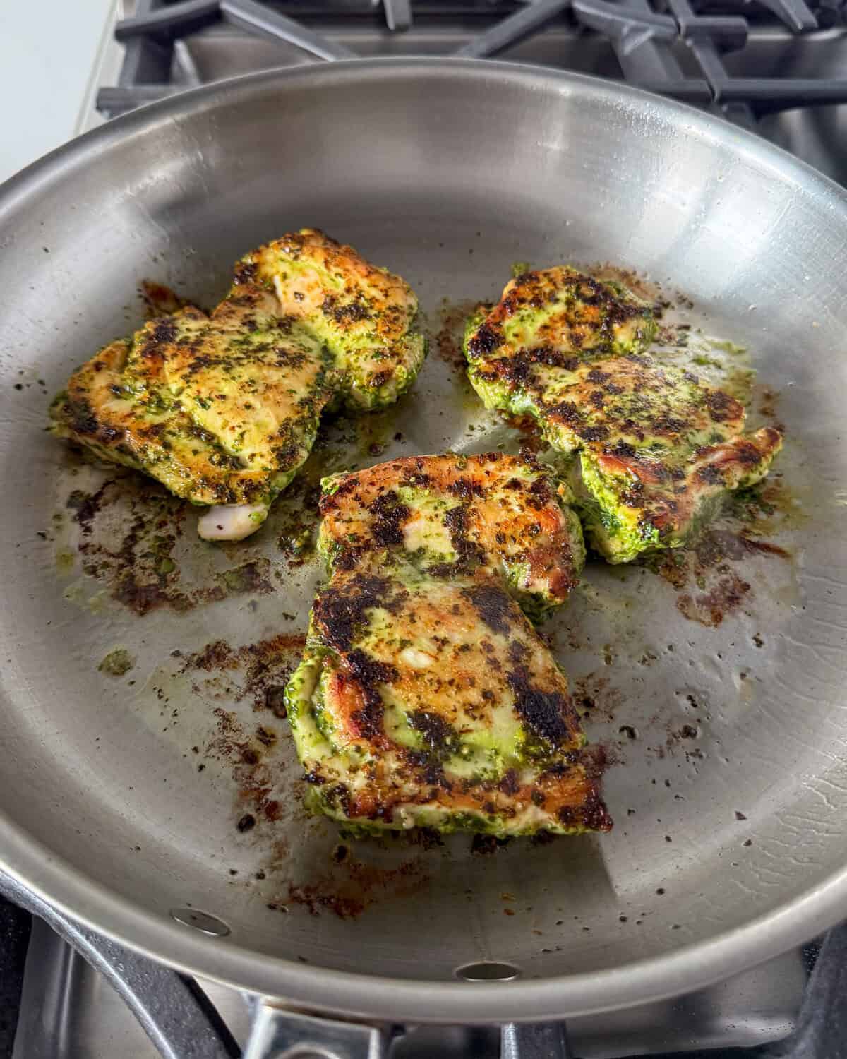Three seared chicken thighs for a Pasta Salad with Roasted Vegetables.