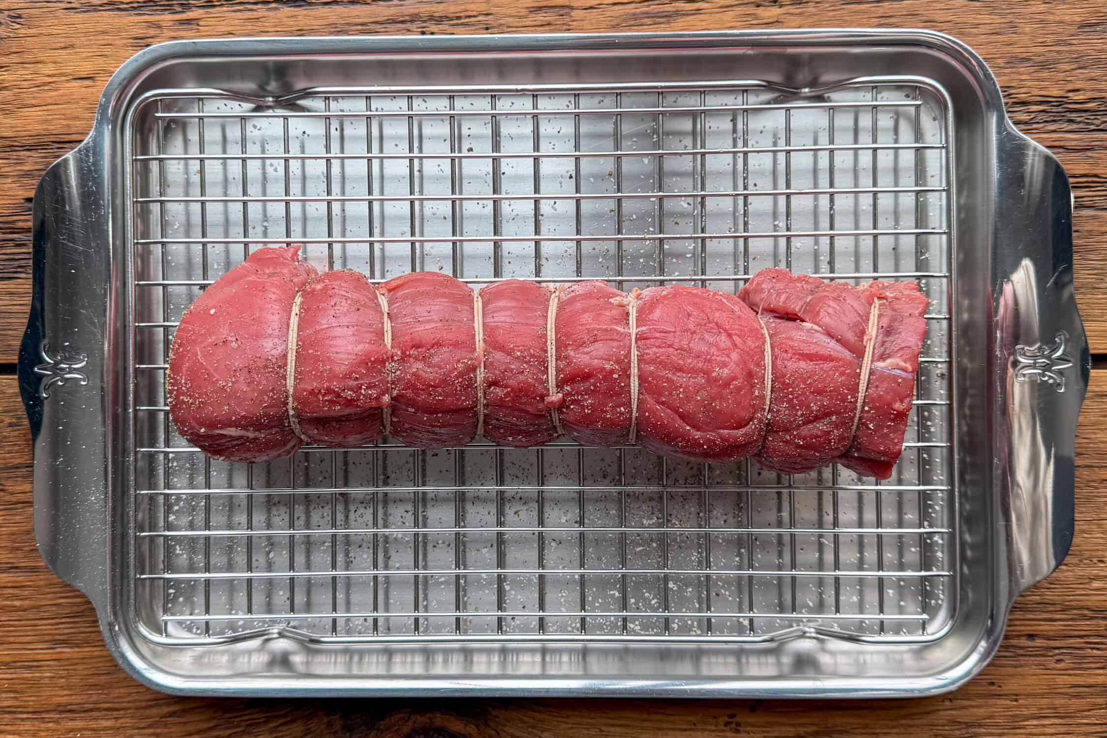 Season the veal with salt and pepper, then place the veal on a wire rack set over a baking sheet.