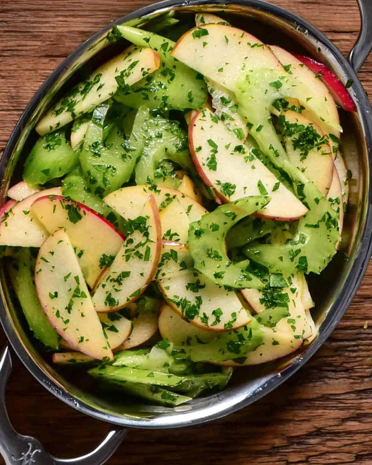 A crisp celery apple salad with lemon-parsley vinaigrette in an oval au gratin.