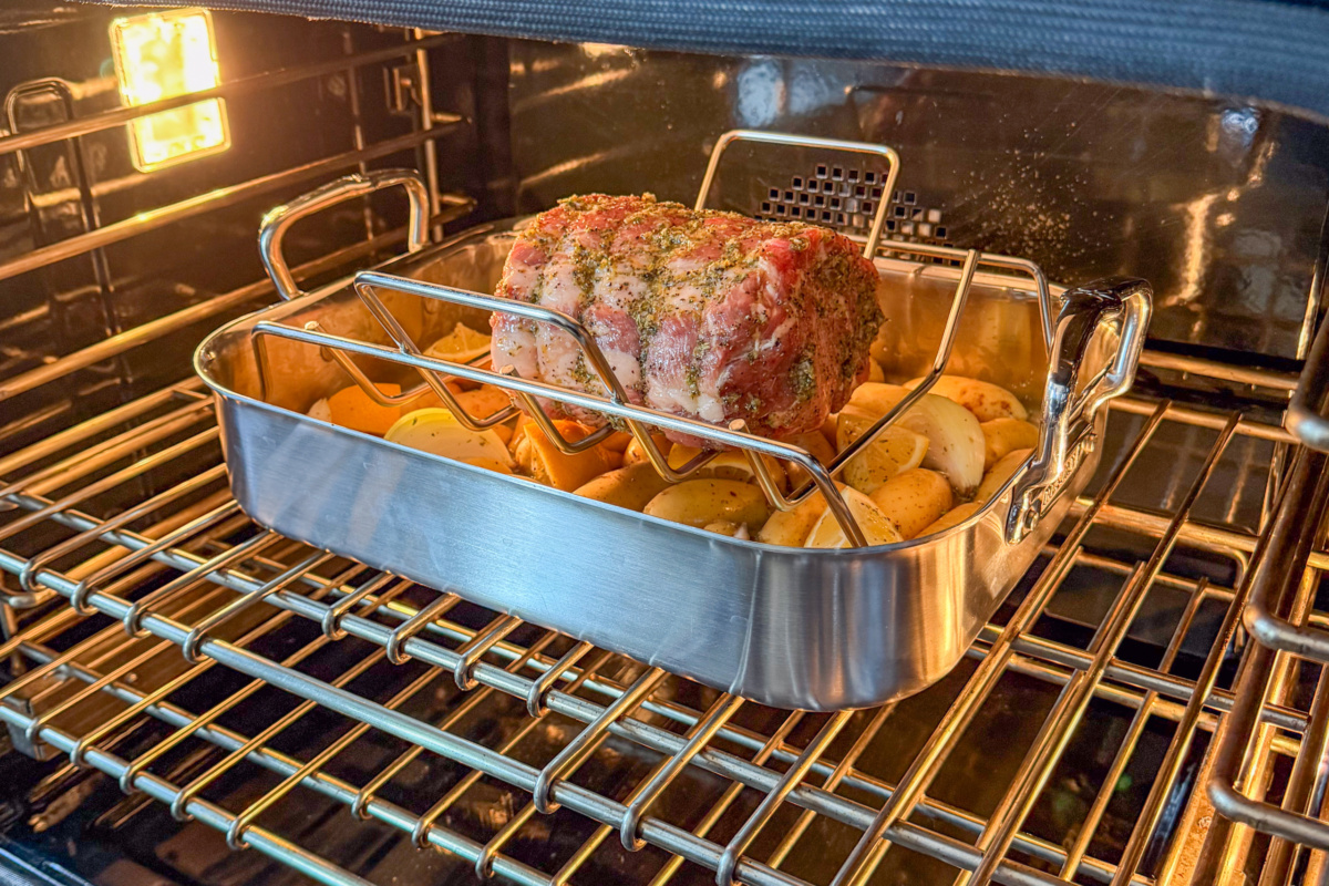 Place the roaster in the oven with the Greek pork roast and potatoes.