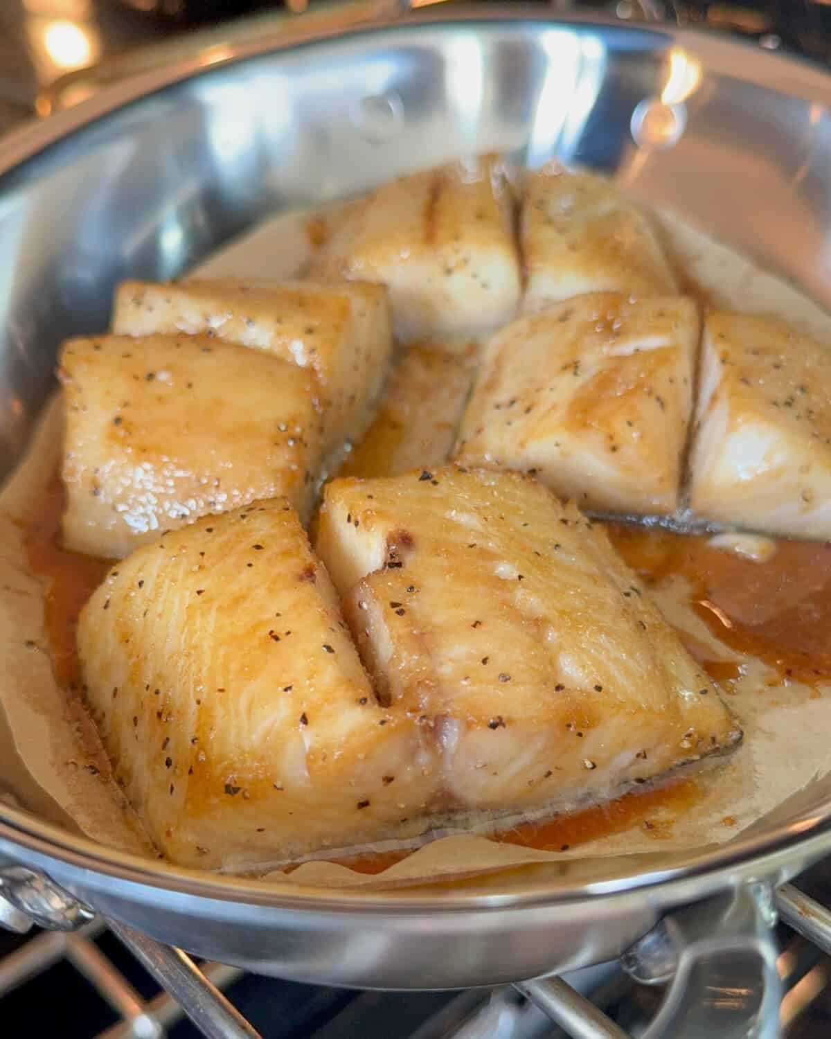 Four pieces of baked black cod in an au gratin.