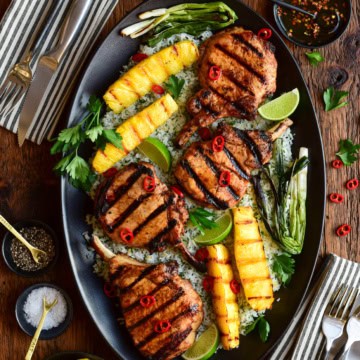 Chili-Lime Pork Chops with Grilled Pineapple served family-style over herb-lime jasmine rice.