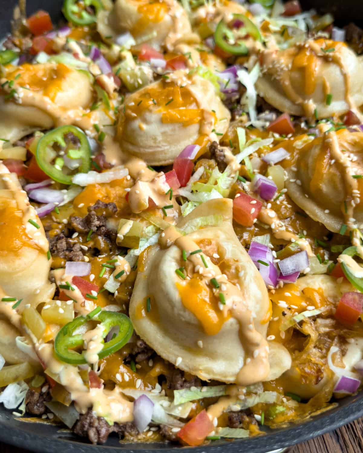 A close up view of a Crispy Cheeseburger Pierogi Skillet with Caramelized Onions.