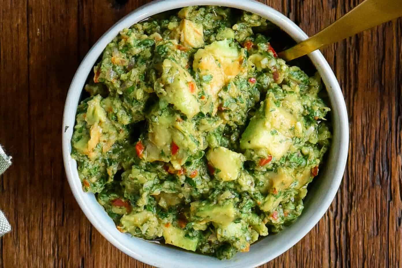 A bowl of Grilled avocado chimichurri salsa.