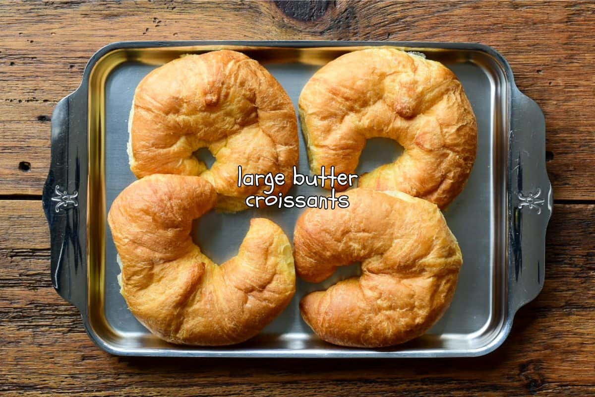 Four big fluffy croissant buns for a peameal bacon sandwich recipe.