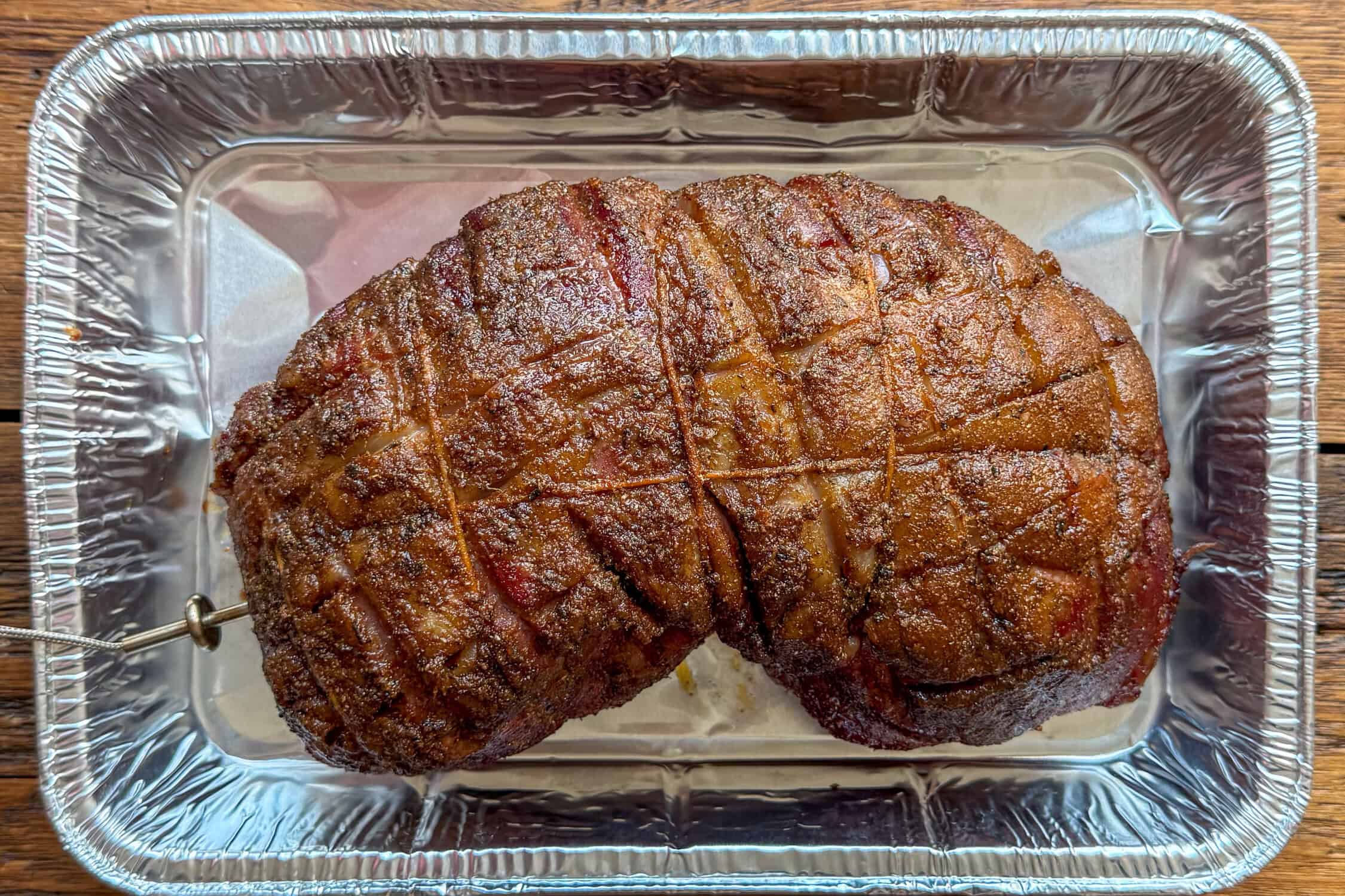 Place the smoked boneless leg of lamb in a tray when it has reached temperature in the low cook.