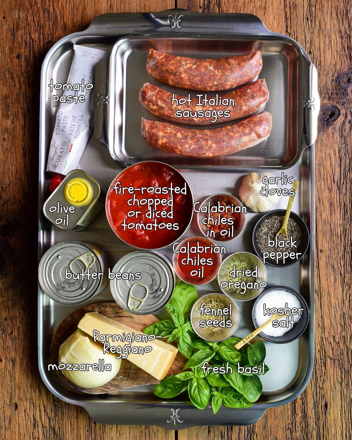 Ingredients laid out on a sheet pan for a pizza beans recipe.