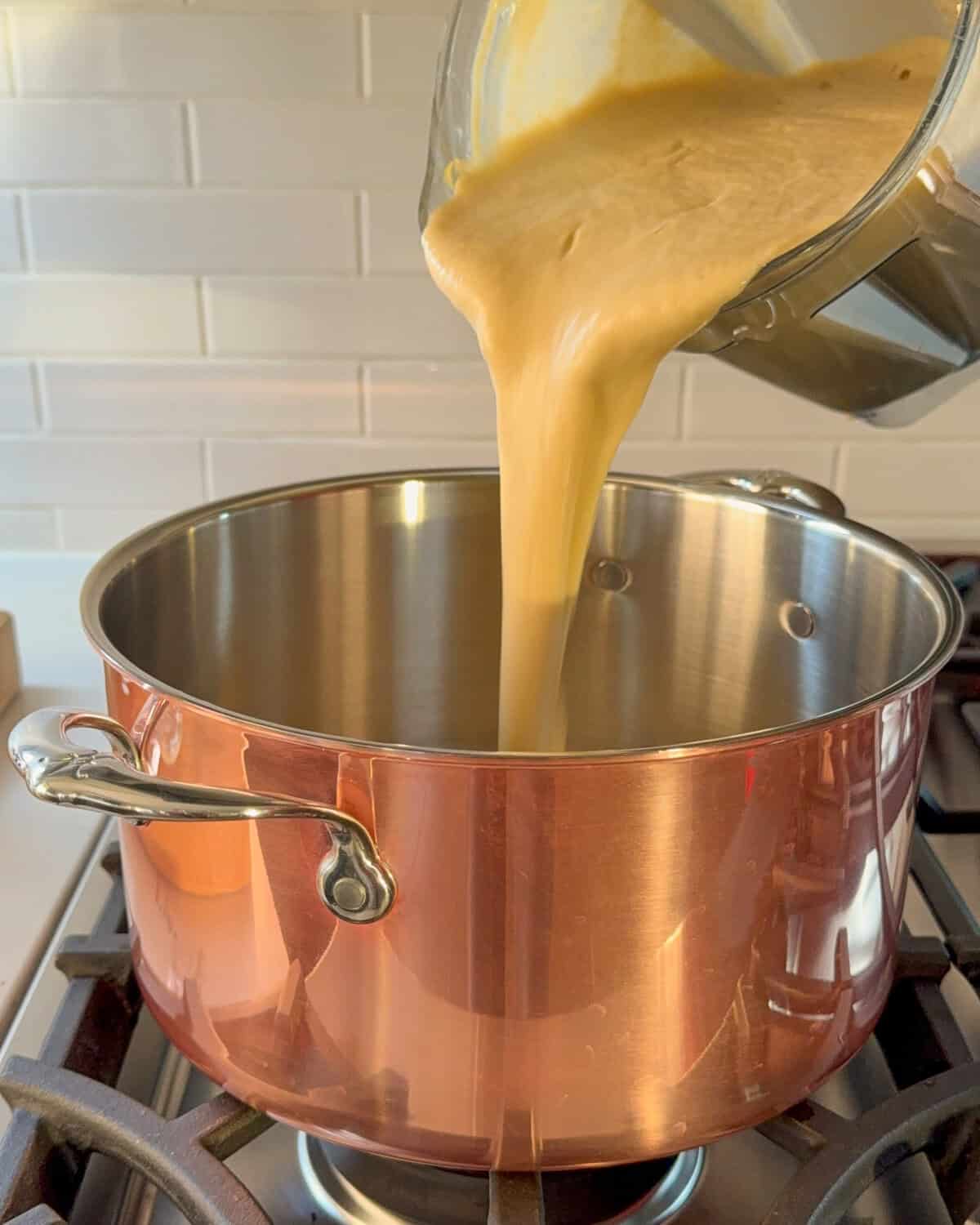 Puree the cauliflower leek soup, then pour it back into a clean pot.