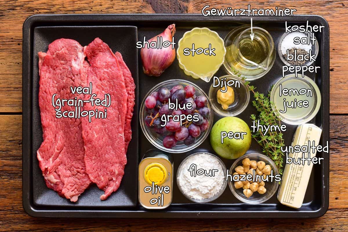 Ingredients for a Veal Scallopini with Ontario Blue Grapes & Pears recipe laid out on a sheet pan.