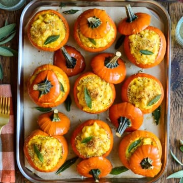 Delicious mini pumpkin mac & cheese baked in mini orange pumpkin shells, perfect for fall snacks or holiday appetizers.