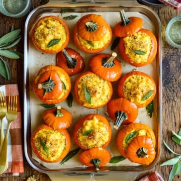 Delicious mini pumpkin mac & cheese baked in mini orange pumpkin shells, perfect for fall snacks or holiday appetizers.