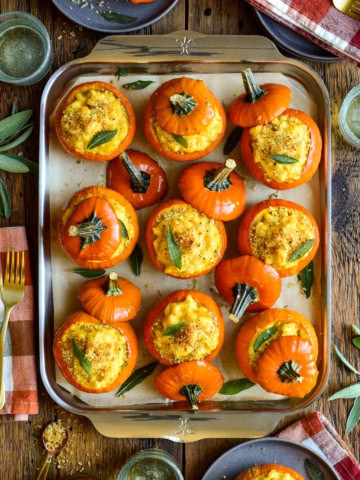 Delicious mini pumpkin mac & cheese baked in mini orange pumpkin shells, perfect for fall snacks or holiday appetizers.