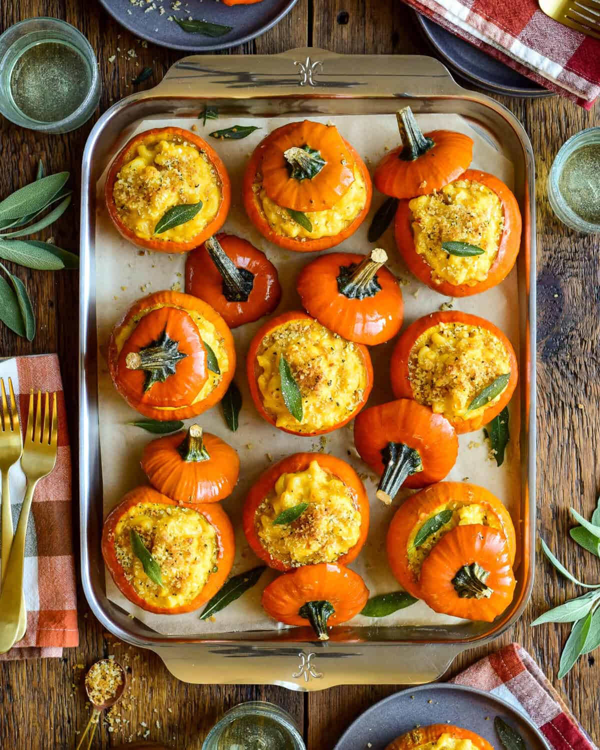 Delicious mini pumpkin mac & cheese baked in mini orange pumpkin shells, perfect for fall snacks or holiday appetizers.