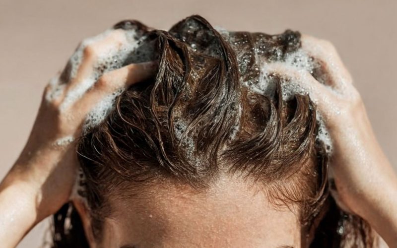 Woman Washing hair with shampoo