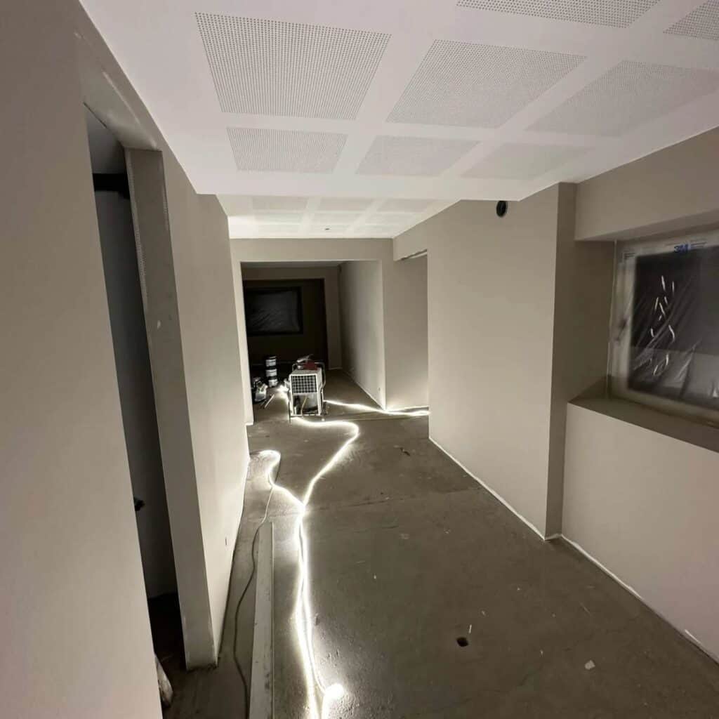 Moderne hvid gang med indbyggede lysstriber i loftet