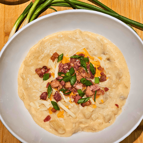 Delicious crockpot potato soup topped with cheese, bacon, and green onions, perfect for cozy comfort.