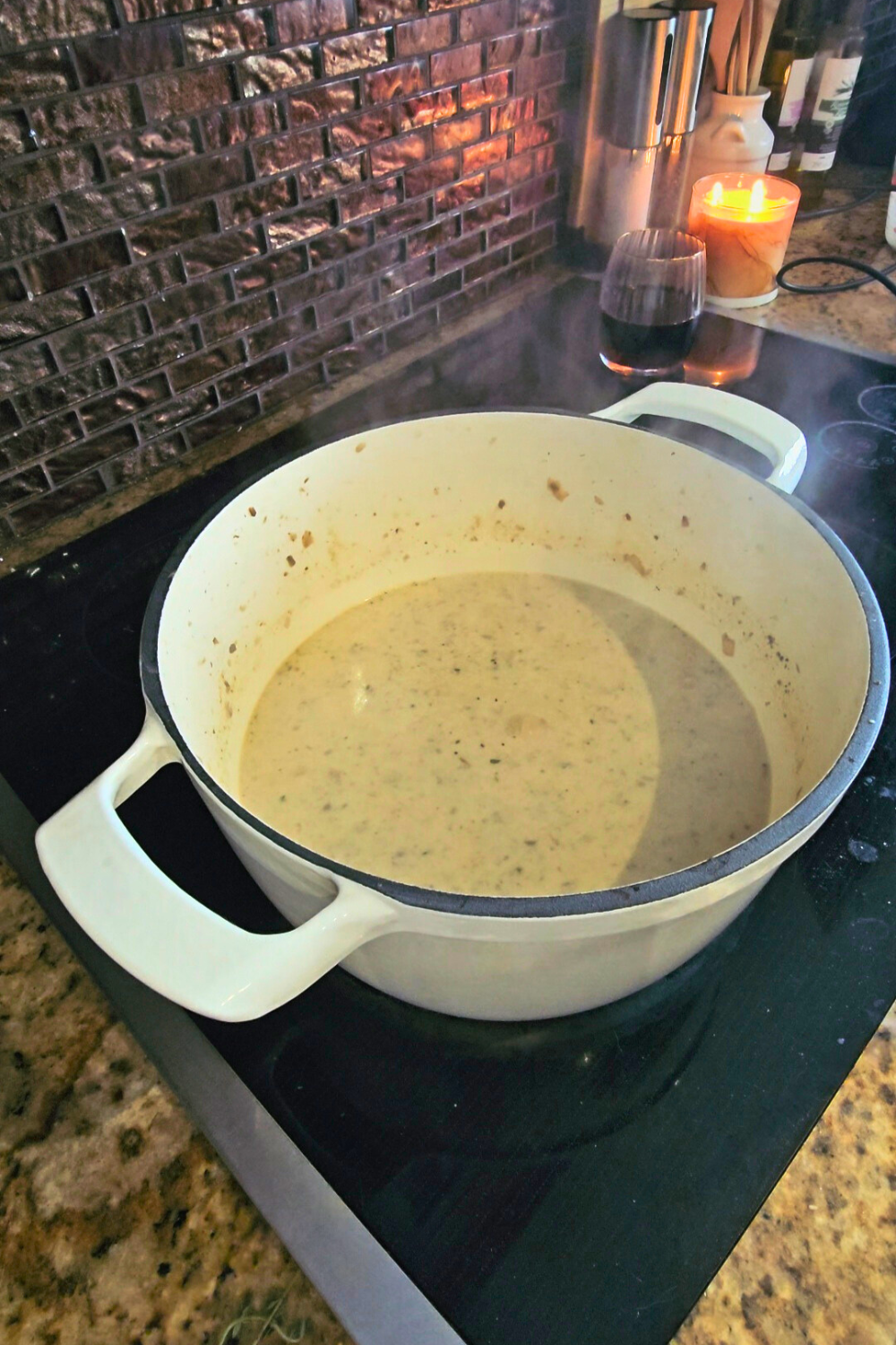 A bowl of mushroom soup boils on a stovetop
