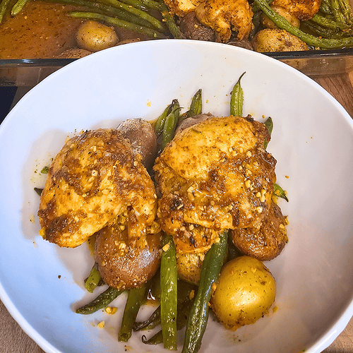 Delicious roasted chicken with potatoes and green beans, served in a cozy, flavorful dish perfect fo.