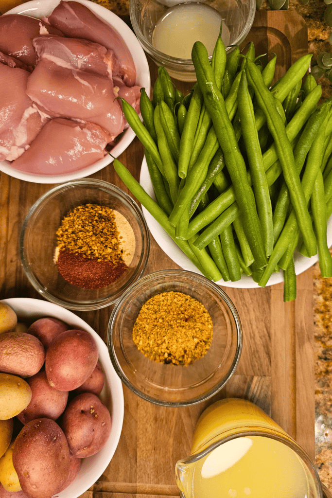 Fresh green beans and raw chicken breasts for nutritious cooking and meal prep.
