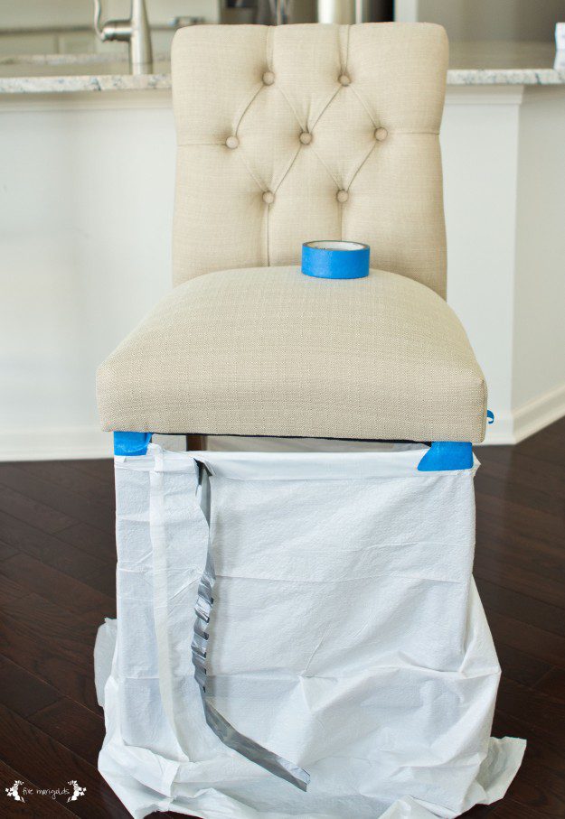Getting it done: I used painter tape and a garbage bag to protect the wood legs from the Scotchgard.