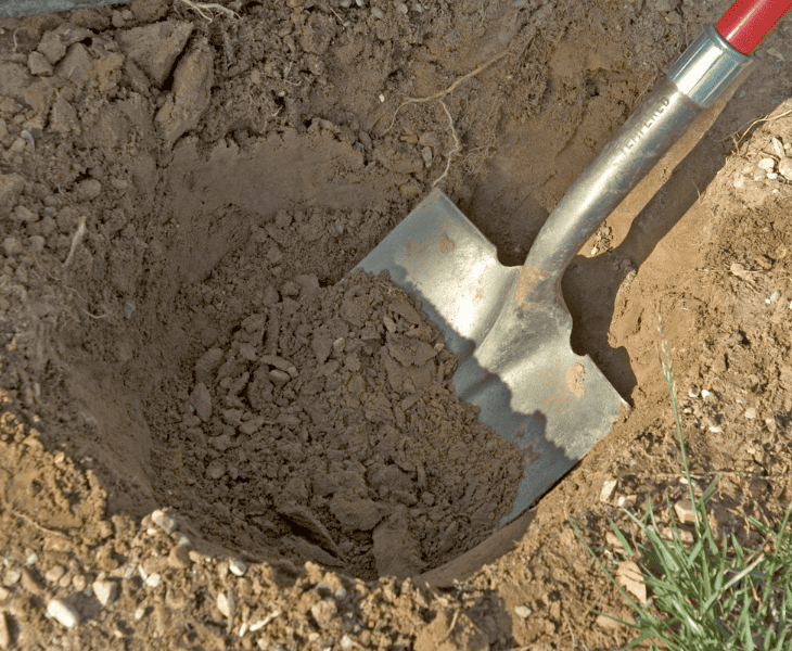 digging a hole with a shovel