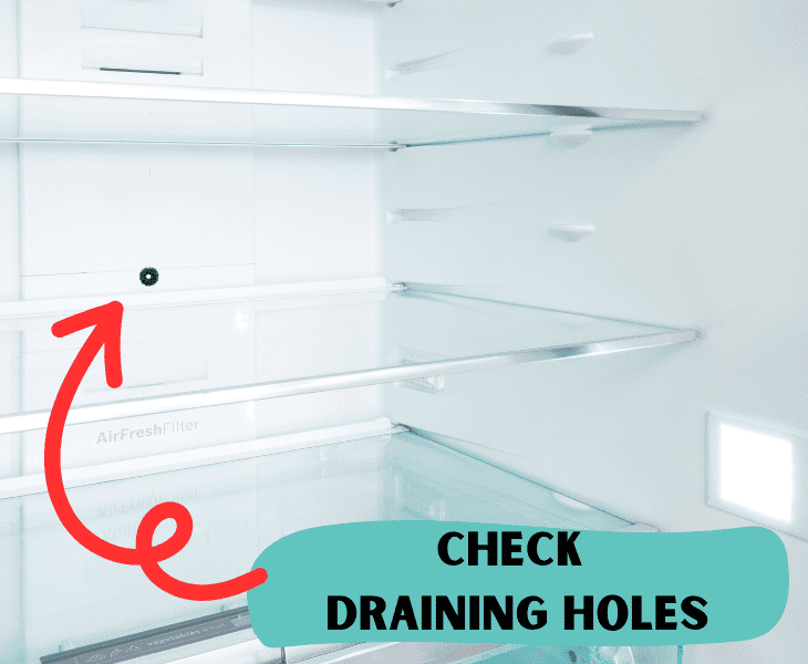 checking draining holes of the fridge