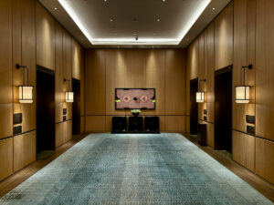 Hotel elevator lobby with a long carpet runner, an example of an area that needs high traffic carpet cleaning
