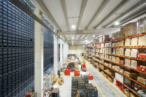 Industrial warehouse filled with stacked boxes, a typical environment for industrial odor control