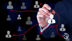Hand drawing a network diagram with interconnected user icons for data analysis.